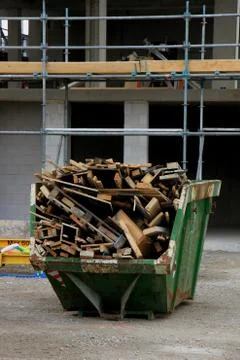 Loaded dumpster near a construction site, home renovation Stock Photos
