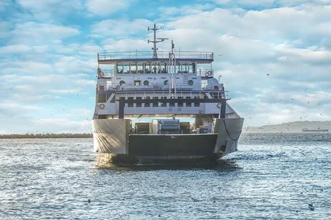 Loaded ferry moves to another side Stock Photos