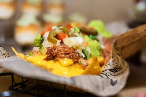 Loaded pulled pork nachos with melted cheese and fresh toppings Stock Photos