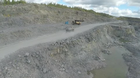 Loaded rock dump truck rides along the road, close-up Stock Footage 104714839