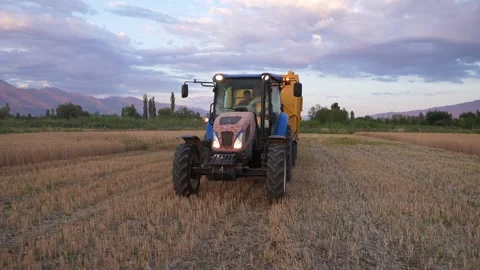 A loaded tractor in the field Stock Footage 241736335
