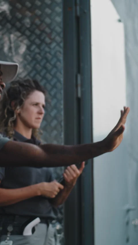 Loader and Female Manager with Tablet Computer Standing Outside of Logistics Stock Footage 312277679