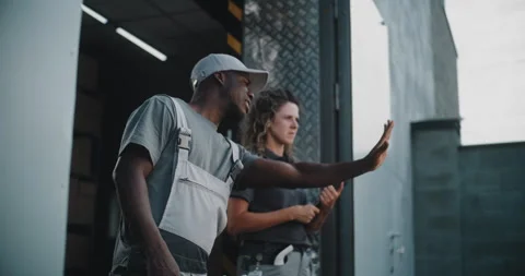 Loader and Female Manager with Tablet Computer Standing Outside of Logistics Stock Footage 312278046
