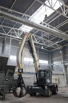 Loader and grab crane for handling waste. Photos