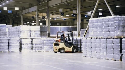 Loader on the background of a huge industrial food warehouse with plastic PET Stock Footage