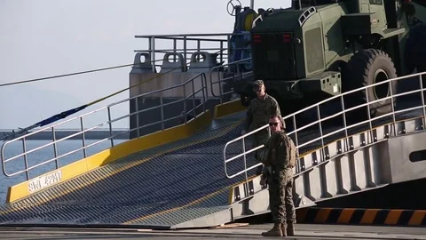 Loader being driven up ramp of USNS Guam (HST1) at Iwakuni  Stock Footage 83448608