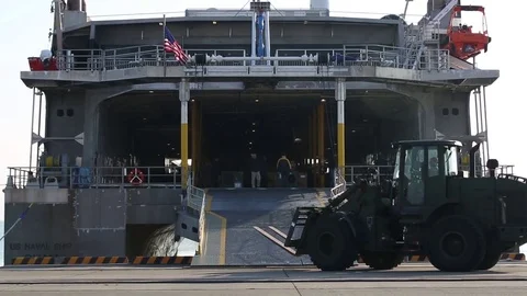Loader boarding USNS Guam (HST1) at Iwakuni to unload cargo Stock Footage 83448481