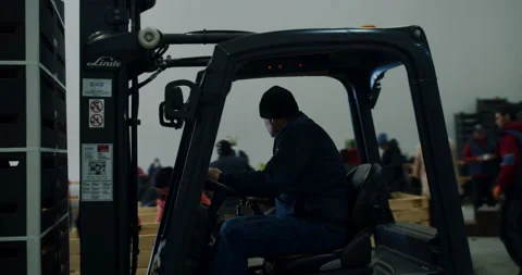 The loader carries large crates to the apple store Stock Footage 171807355