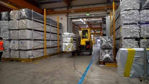 Loader carries plastic profiles to the warehouse Stock Footage 93447937