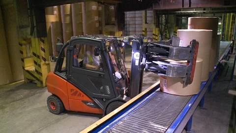 Loader carries rolls of paper in the warehouse of finished products. 스톡 동영상 105534972