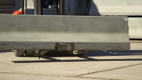 A loader is carrying a concrete barrier Stock Footage 263967052