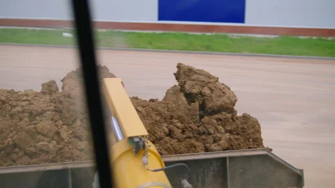 A Loader carrying red clay Stock Footage 158926771