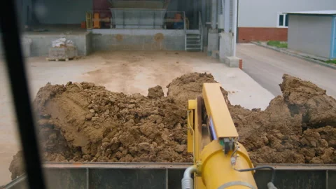 Loader carrying red clay to the storage area Stock-Footage 165098248