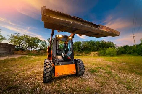 Loader clears a construction site. Land works for landscaping. A machine for Stock Photos