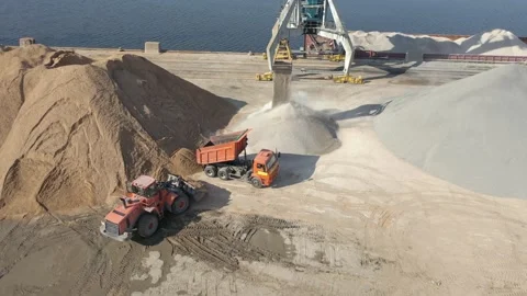 Loader crane unloads sand. Aerial view. Stock Footage 169949649