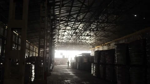 The loader driver loads and unloads pallets with bags in a very dark warehouse Video stock 156382334