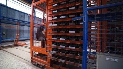Loader driver transports stacks of bricks on a forklift on construction factory Stock Footage 128160431