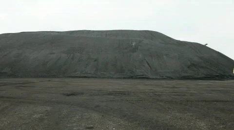Loader driving trough still shot of pile of coals 動画素材 665336