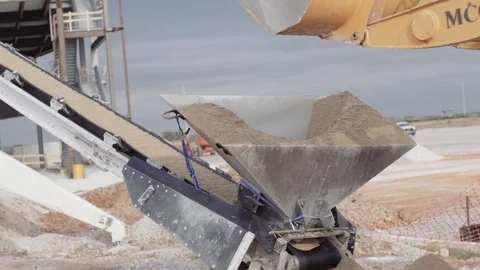 A Loader Drops Dirt Into A Dirt Conveyor Stock Footage 87511113