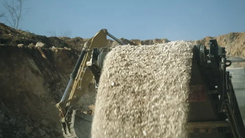 Loader excavates and loading stone pieces in rock crushing machine, open pit Video stock 294070961