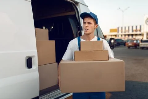 Loader holding stack of parcels, delivery service 写真素材