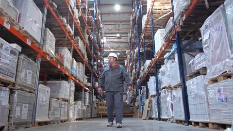 The loader is on a huge warehouse, the general plan, the camera in motion. 4K Stock-Footage 111768289