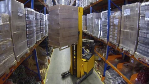 The loader lifts the boxes. Big Retail Warehouse full of Boxes and Packages. Stockbeeldmateriaal 195704931