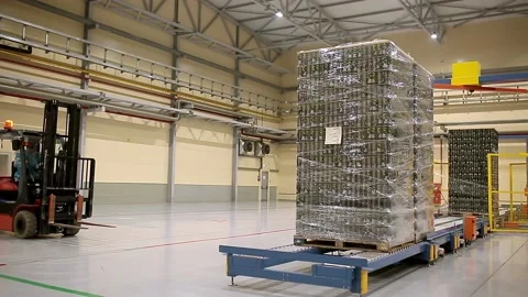 Loader loading packaged products at the factory. Stock Footage 218860415