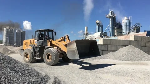 The loader loads the crushed stone into its bucket. Stock Footage 131434419