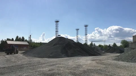 The loader loads the crushed stone into its bucket. Stock Footage 131434450