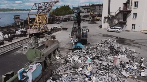 Loader loads metal waste into press recycling machine Stock Footage