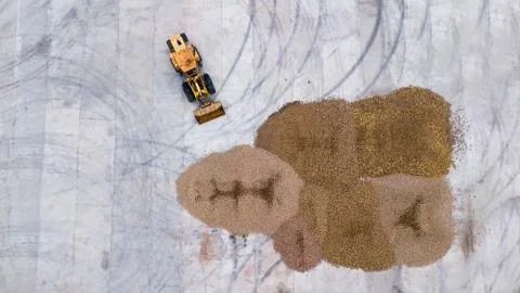 The loader loads the potatoes top view from the drone Stock Photos