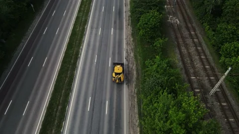 Loader moves along the asphalt road. aerial shooting Stockbeeldmateriaal 157714555