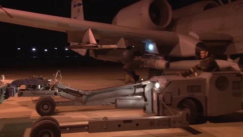 A Loader Moves by A Military Plane* Stock Footage 115128629