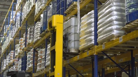Loader operator on stacker take cargo from the rack Stock Footage