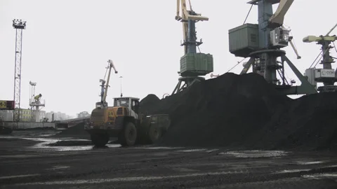 Loader picks up bucket of coal against the backdrop of seaport with huge cranes Stock Footage 205238490