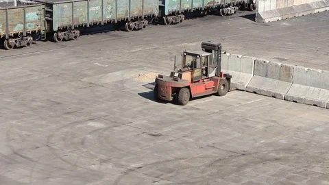 A loader at the port berth moves concrete blocks to form bulk cargo boundaries Stock Footage 120702579