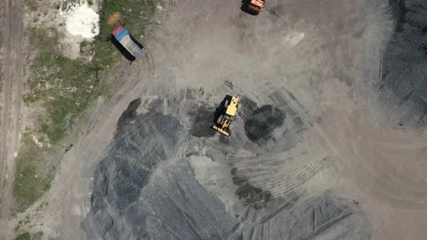 Loader pours crushed stone from a large pile into a small one Video stock 156728751