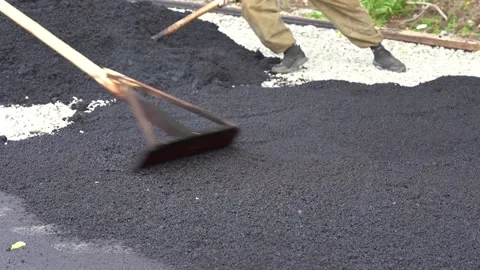Loader pours hot asphalt Stock Footage 138861815