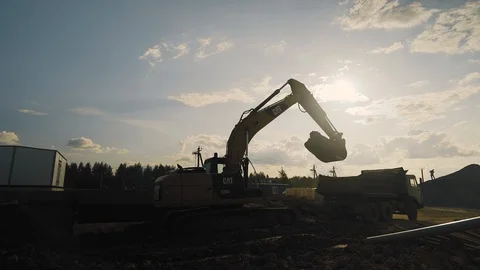 Loader pours into a truck at a construction site Stock Footage 124664955