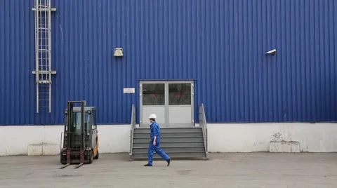 Loader sits in electric forklift and drive it Stock Footage 64587537