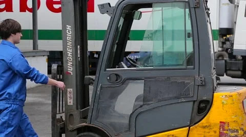 Loader sits in electric forklift Stock Footage 64587388