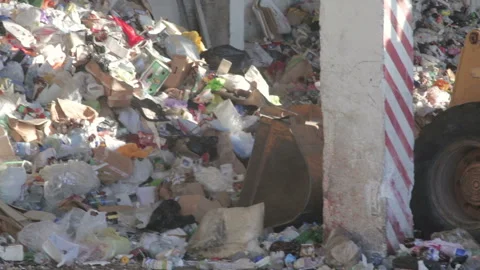 Loader unloads trash, paper, plastic and household waste at a recycling plant. Stock Footage 125646738