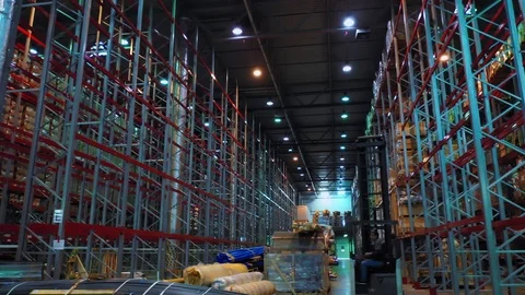 The loader works between giant metal shelves of a wholesale construction Stock Footage 113091508