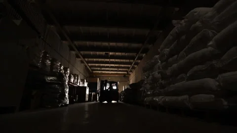 The loader works in the warehouse between the rows with products Stock Footage 134004219