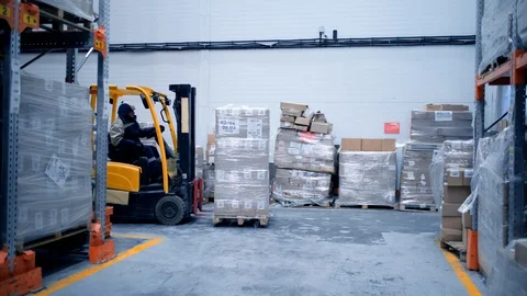 Loader works on the warehouse construction site, shipment of goods, boxes with Stock Footage 127927723