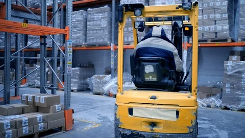Loader works on the warehouse construction site, shipment of goods, boxes with Stock Footage 127928136