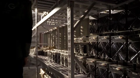 Loaders bring in bitcoin ASIC miners to steel shipping container warehouse Stock Footage 158733475