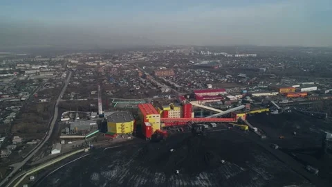 Loaders collect coal for loading at processing plant. Factory on background of Stock Footage 203920809