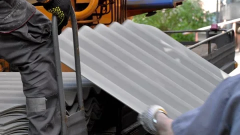  Loaders make unloading of building materials. Roofing materials Stock Footage 197014725